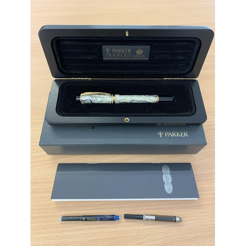 124 - A boxed Parker Duofold International fountain pen with 18ct gold nib, spare inks and instructions