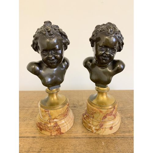 215 - After Claude Michel 'Clodion', a pair of bronze busts on marble bases, marked 'Clodion' to the backs... 