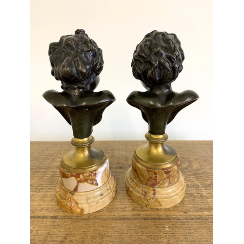 215 - After Claude Michel 'Clodion', a pair of bronze busts on marble bases, marked 'Clodion' to the backs... 