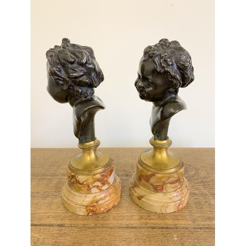 215 - After Claude Michel 'Clodion', a pair of bronze busts on marble bases, marked 'Clodion' to the backs... 