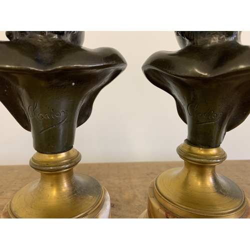 215 - After Claude Michel 'Clodion', a pair of bronze busts on marble bases, marked 'Clodion' to the backs... 