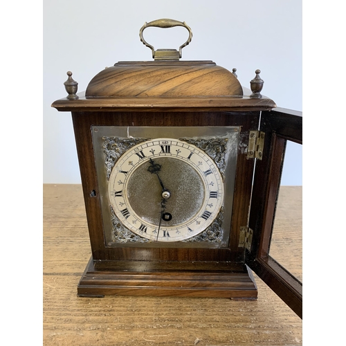 218 - A vintage mahogany cased key wind mantel clock, no obvious maker, brass handle and corner decoration... 