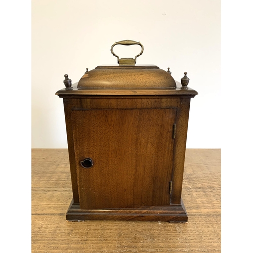 218 - A vintage mahogany cased key wind mantel clock, no obvious maker, brass handle and corner decoration... 