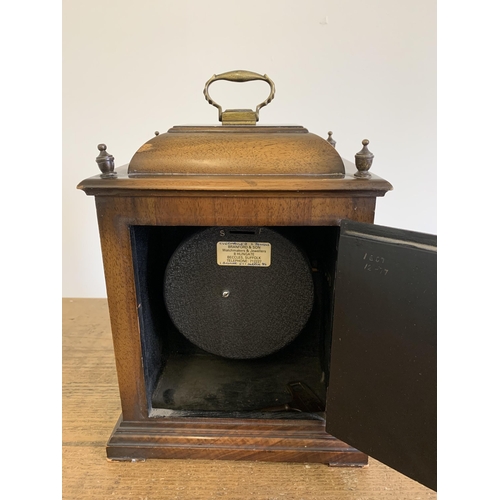 218 - A vintage mahogany cased key wind mantel clock, no obvious maker, brass handle and corner decoration... 