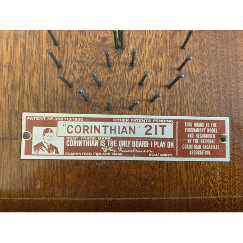 219 - A boxed vintage Corinthian 21T bagatelle board with pusher and ball bearings