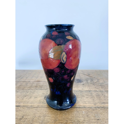 277 - A Moorcroft pomegranate pattern small vase, green signature to base, approx. 7 1/2