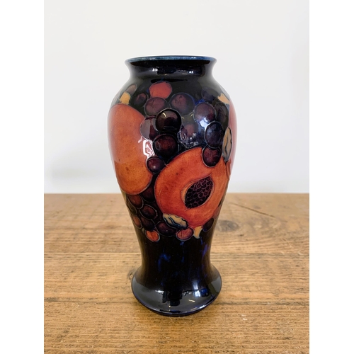 277 - A Moorcroft pomegranate pattern small vase, green signature to base, approx. 7 1/2