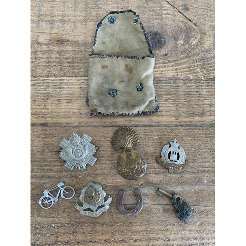 283 - A selection of vintage military cap badges