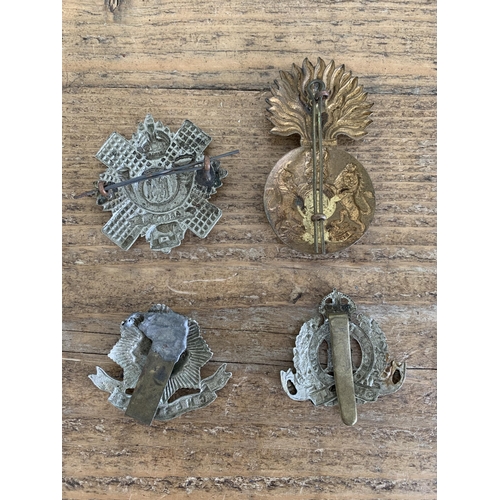 283 - A selection of vintage military cap badges