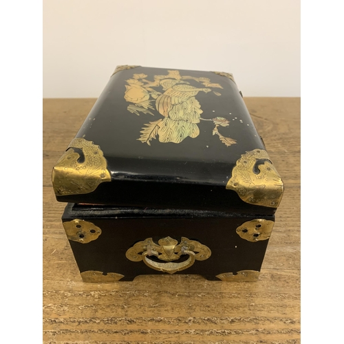 332 - A vintage Chinese black lacquer jewellery box inlaid with mother of pearl and brass ornamentation, t... 