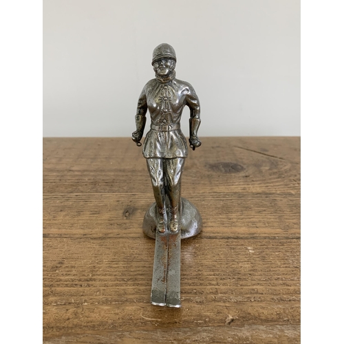 38 - An original scarce 1930's white metal car mascot 'Ski Lady' for the Riley Alpine car, marked to the ... 