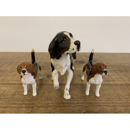 75 - A Royal Doulton spaniel, two 'Breed Apart' dogs plus two Beswick fox hounds (one as found to leg)