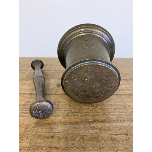 87 - An 18th Century large bronze pestle and mortar, 6