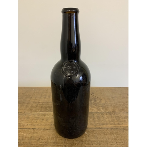 98 - A vintage Williams & Humbert Jerez sherry bottle with stamp dated 1877, brown glass, 13