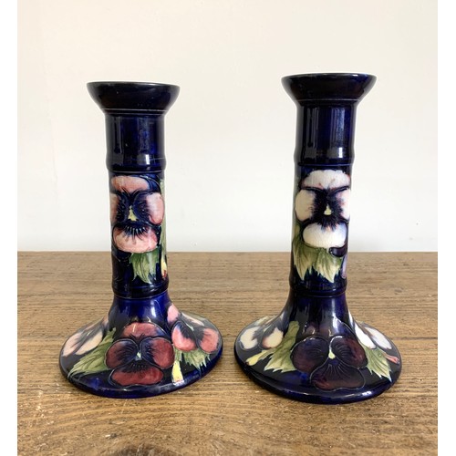 278 - A matched pair of Moorcroft pansy pattern candlesticks, blue signature and label to base, approx. 7 ... 