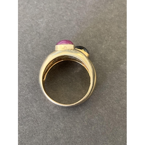 137 - A two-tone gold double ring, one set with a sapphire, the other a ruby, one band bears hallmarks for... 