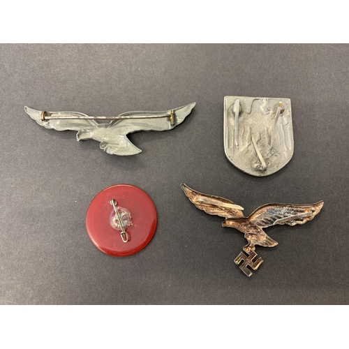 157 - Two WW2 German badges to include a Assman Breast Eagle (missing swastika) and an N.S.D.A.P. red plas... 