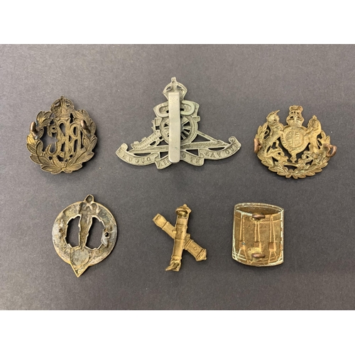 160 - Five mixed WW1 and WW2 cap badges plus a 1930's 32nd Artillery badge