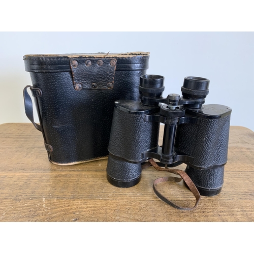 167 - A pair of cased Tecnar by Swift binoculars 12x50, good optics (case as found)