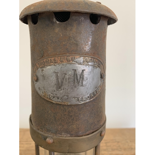 209 - An original vintage brass miners lamp with attached plaque 'E.Thomas & Williams Ltd', stamped 'VM' t... 