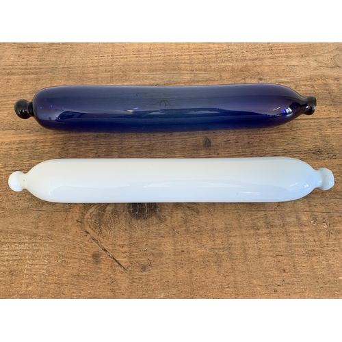 230 - An antique Bristol blue glass rolling pin together with a white glass example with traces of old dec... 