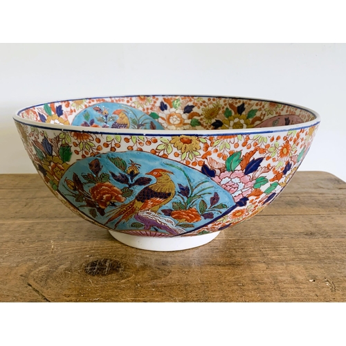 237 - A large hand painted Oriental punch bowl decorated with birds and flowers, Oriental characters to ba... 