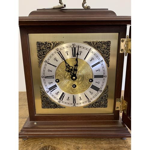 30 - A vintage Western Germany key wind striking mantel clock with key, approx. 13 1/2