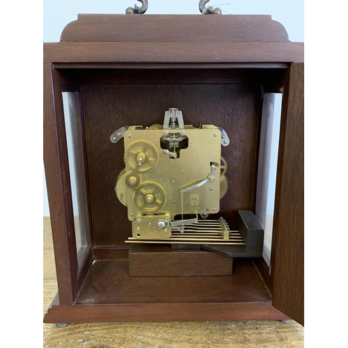 30 - A vintage Western Germany key wind striking mantel clock with key, approx. 13 1/2