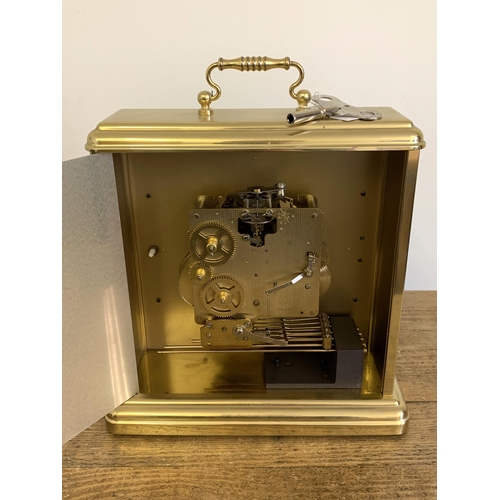 38 - A large brass cased Hermle German movement, key wind chiming mantel clock, with key, 11 1/2