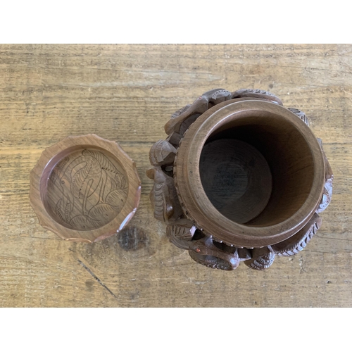 40 - A possibly Indian carved wood lidded bowl decorated with birds, approx. 9