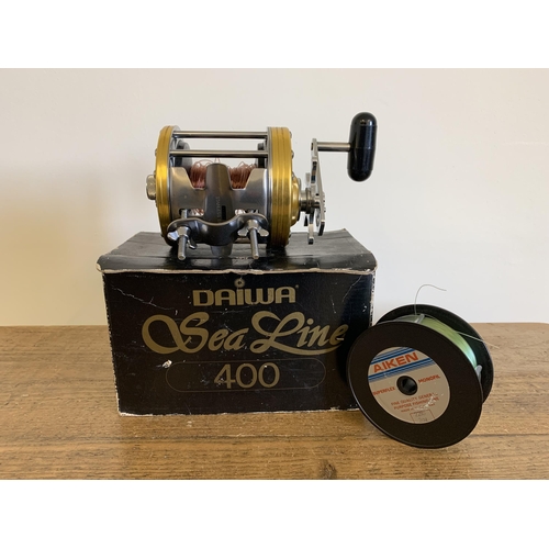 41 - A boxed Daiwa sea line 400 fishing reel and spare spool (used, but clean condition, box with wear)