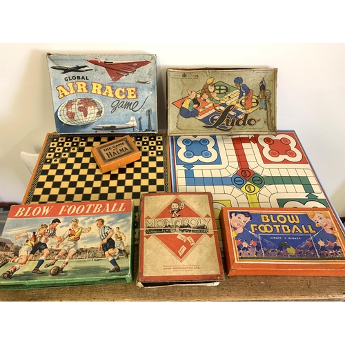 58 - Various vintage board and table games including an early Monopoly, two Blow Football, boxed 'Air Rac... 