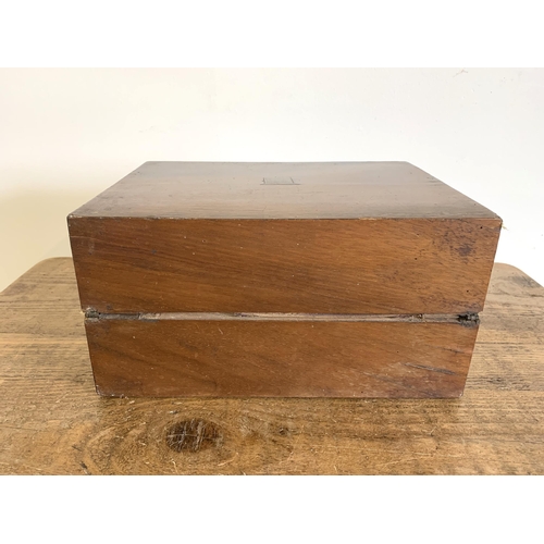 80 - A late 19th Century mahogany writing slope with velvet interior and glass ink bottle