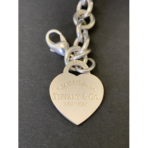 136 - A fine and heavy Tiffany & Co 925 sterling silver '1837' charm bracelet with three fully marked char... 