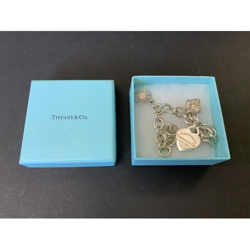 136 - A fine and heavy Tiffany & Co 925 sterling silver '1837' charm bracelet with three fully marked char... 