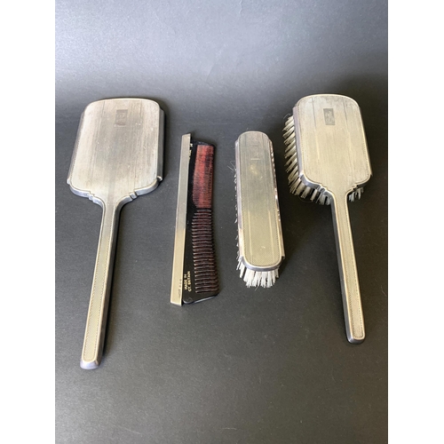 141 - A four piece hallmarked silver dressing table set, Birmingham 1948, maker Daniel Manufacturing Co