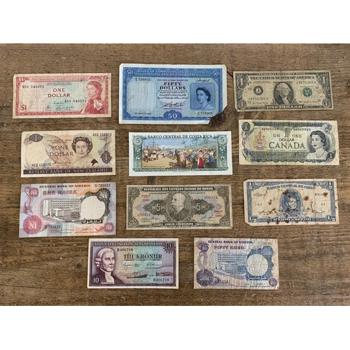 197 - Eleven mixed vintage world banknotes, countries include Malaya and British Borneo, East Caribbean, N... 