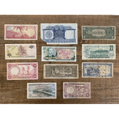 197 - Eleven mixed vintage world banknotes, countries include Malaya and British Borneo, East Caribbean, N... 