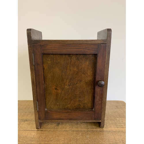 22 - A small wooden one door cabinet, 15 1/2