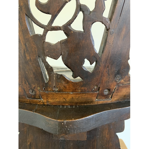 270 - A late 19th/early 20th Century Sgabello style carved wooden hall chair, carved griffon style creatur... 