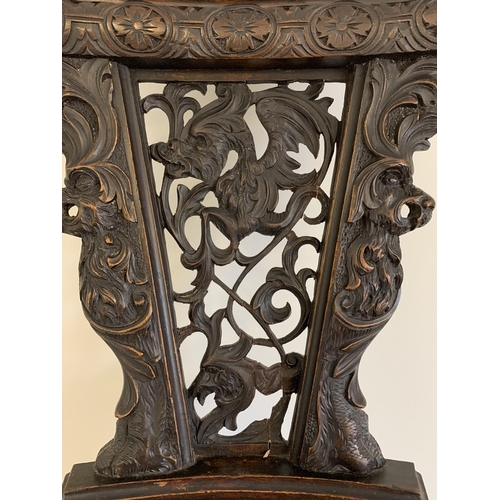 270 - A late 19th/early 20th Century Sgabello style carved wooden hall chair, carved griffon style creatur... 