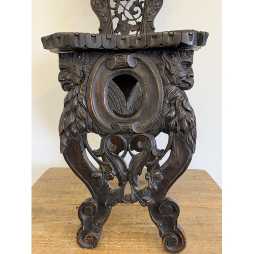 270 - A late 19th/early 20th Century Sgabello style carved wooden hall chair, carved griffon style creatur... 