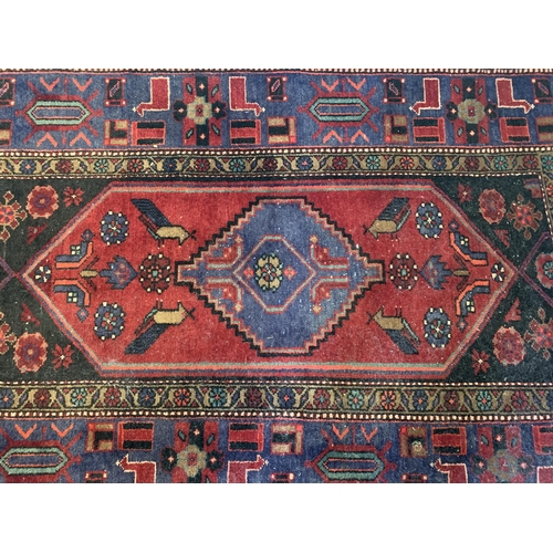 278 - A dark red ground floor rug with small fringe, 77