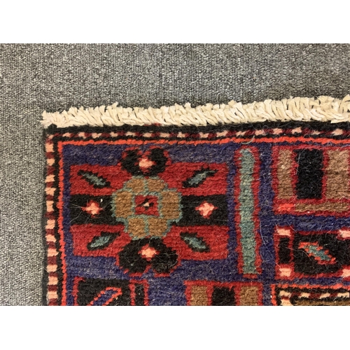 278 - A dark red ground floor rug with small fringe, 77