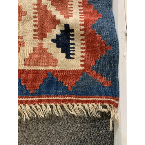 279 - A multi coloured hessian floor rug with tassels, approx. 101