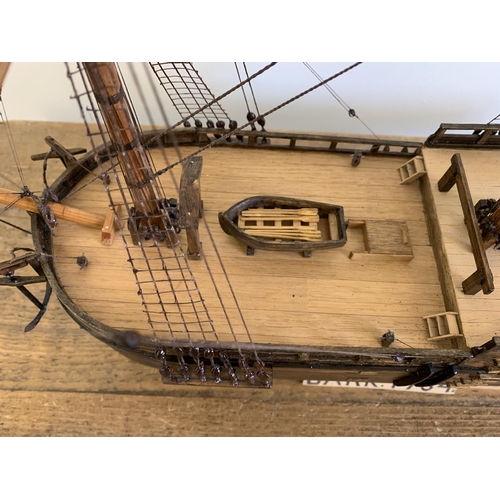 292 - A scratch built boat of H M Bark in a glass case, approx. case measurements 32