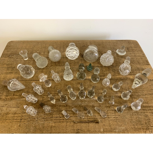 30 - A selection of vintage cut glass decanter and bottle stoppers