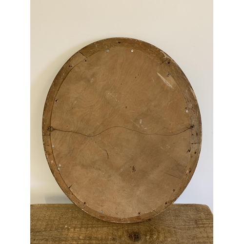 310 - An oval gilt framed mirror with bevel edge, overall dimensions 23 1/4