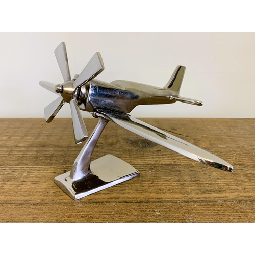 37 - A modern still boxed chrome finish model plane, 7