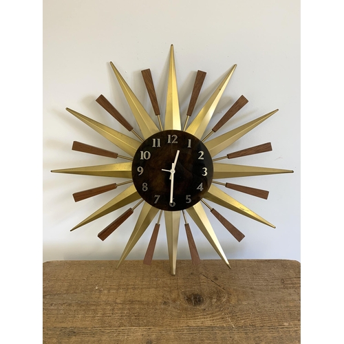 40 - A vintage West German made sunburst battery wall clock, 22 1/2